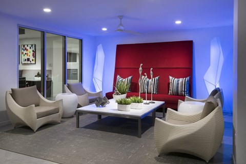 a living room with white chairs and a red couch